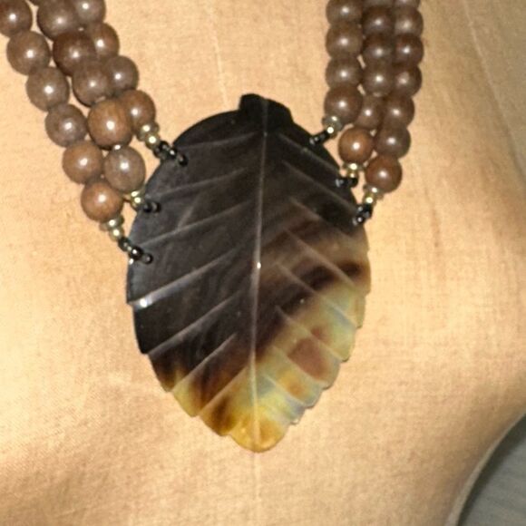 Elegant Brown Wooden Beaded Necklace with Carved Mother of Pearl Leaf Pendant - Picture 3 of 11